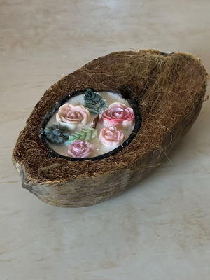 Handmade candle in natural coconut shell