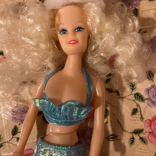 Mermaid doll with clothes used, damaged doll and worn clothes