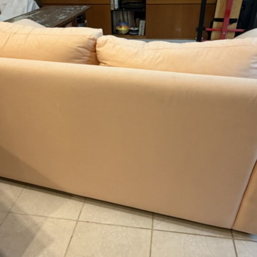 Fabric two-seater sofa used, light pink-peach with side cushions