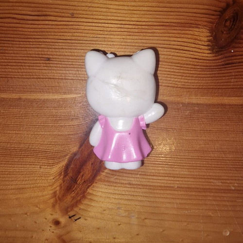 Hello Kitty figure used with pink dress and yellow flower