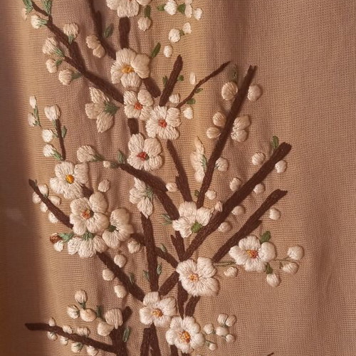 Vintage handmade embroidery with embossed almond blossom design