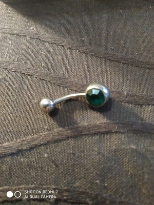 Navel piercing used with green stone titanium