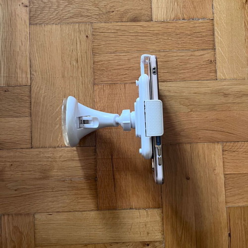 White mobile phone holder used with strong suction cup for car