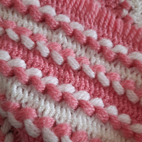 Knitted handmade crib blanket used pink white