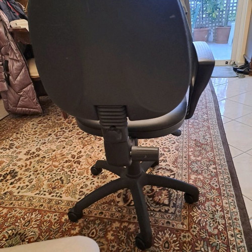 Office chair used with black leatherette upholstery