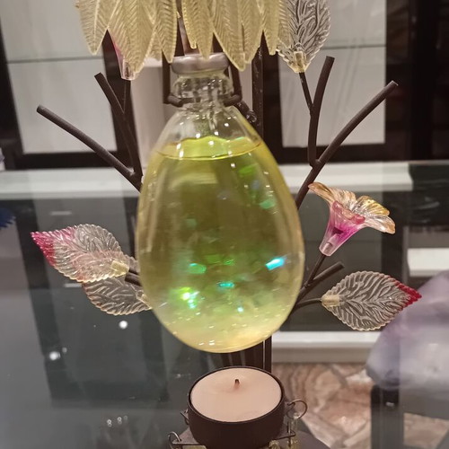 Decorative candle holder with metal tree base, used