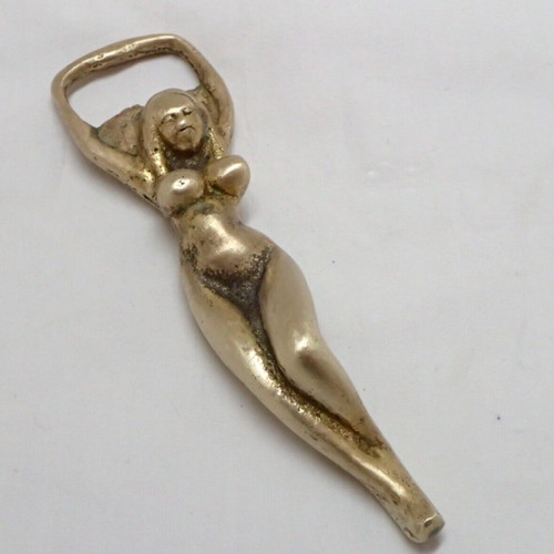 Vintage brass bottle opener shaped like a woman used