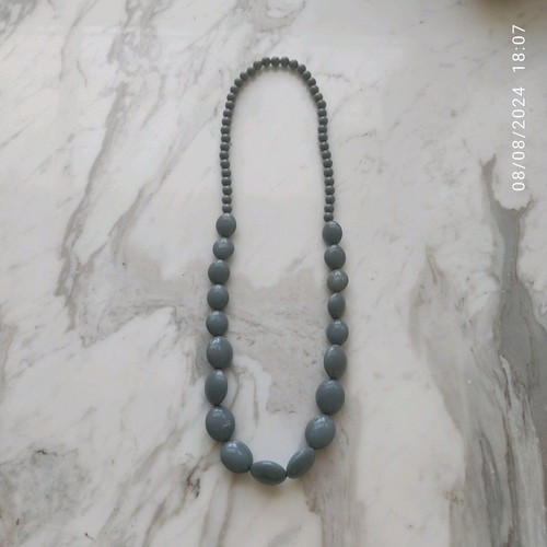 Long necklace with gray celluloid beads used