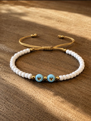 Handmade bracelet with white beads and turquoise acrylic hearts, adjustable