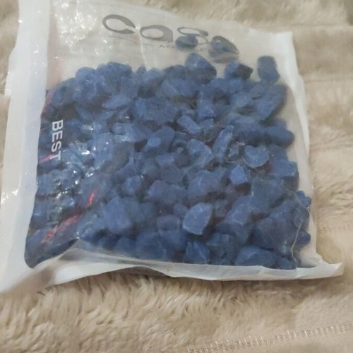 Plastic aquarium used with orange and blue gravel and accessories