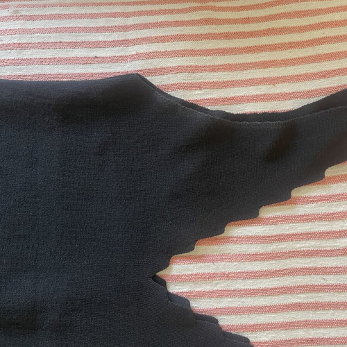 Black knitted sleeveless top with scalloped edges