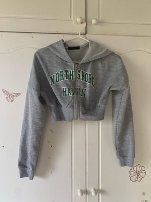 Cropped zip up hoodie used, grey with green lettering, size XS