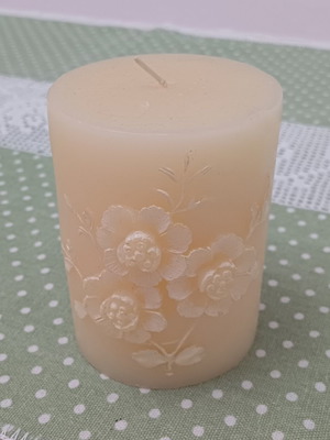Decorative candle with embossed floral design like new, cream color