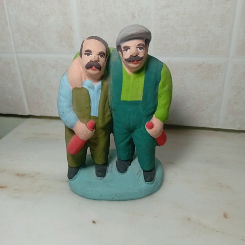 Ceramic figure of two men with traditional costumes like new