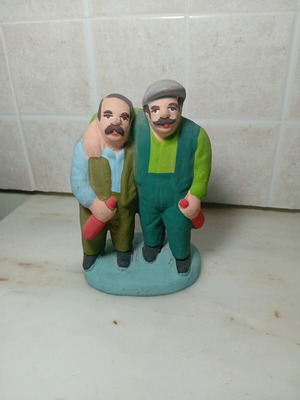 Ceramic figure of two men with traditional costumes like new