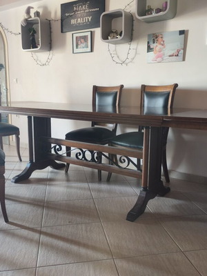 Extendable walnut dining table with 6 leather nailhead trim chairs