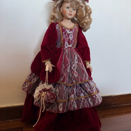 Porcelain doll with burgundy velvet dress like new