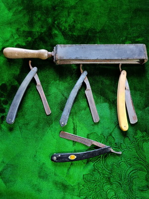 Vintage straight razors with leather strop and wooden handle