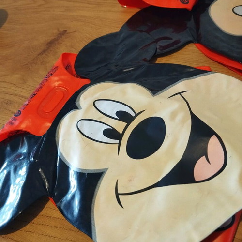 Mickey arm floaties used, red and black with smile