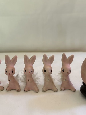 Vintage ceramic pink bunny family figurines with decorative Easter egg