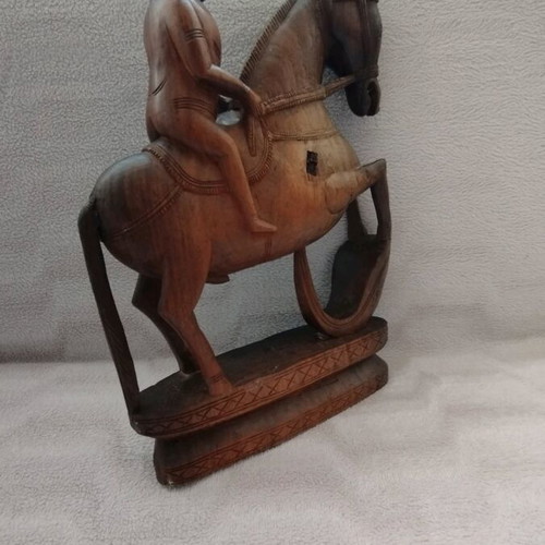 Wooden carving of South Indian man riding horse used
