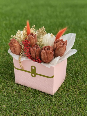 Bouquet of flowers with scented candles in a bag with chain