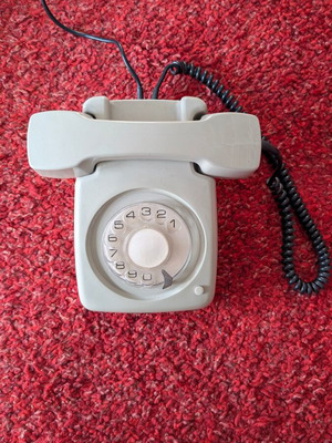 Vintage wired telephone with rotary dial like new, gray-beige