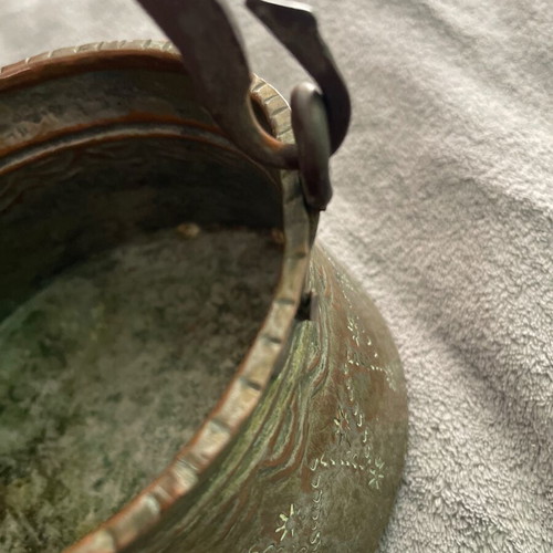 Handmade copper cauldron used with hammered texture and designs