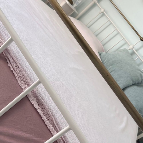 Double wrought iron bed with slats and used mattress