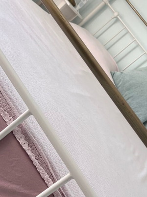 Double wrought iron bed with slats and used mattress