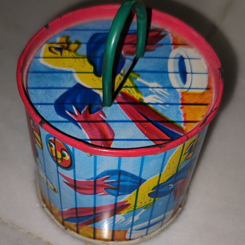 Vintage tin piggy bank used with parrots