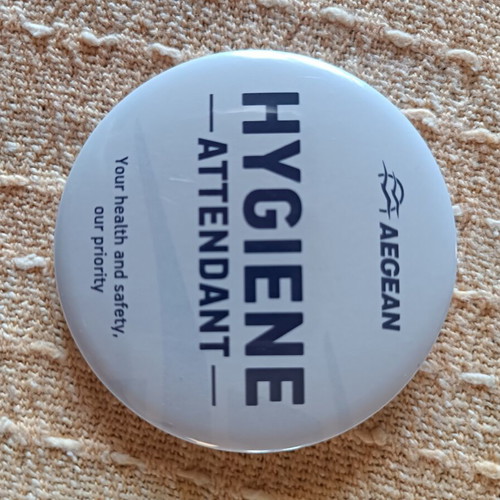 Aegean Airlines lapel pin with old logo and hygiene wipe