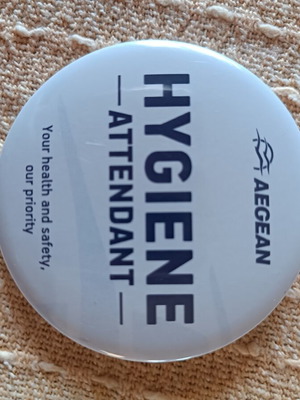 Aegean Airlines lapel pin with old logo and hygiene wipe