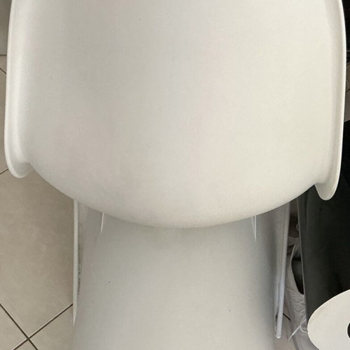 White modern plastic chair with crack