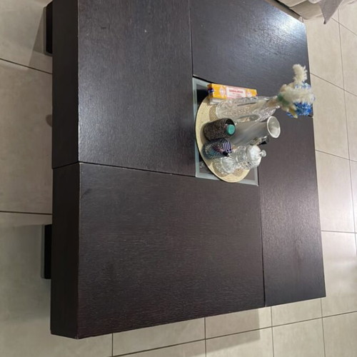 Coffee table made of solid wenge wood with storage and glass center