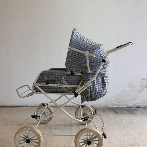 Vintage baby stroller with classic check fabric and metal frame