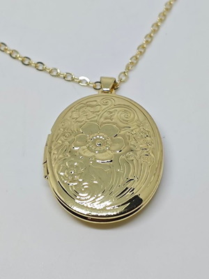 Gold locket necklace like new with floral embossed design