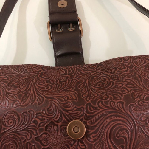 Women's brown shoulder bag used with embossed design
