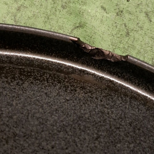 Porcelain plate used, black with small chip