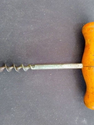 Vintage bottle opener with wooden handle used