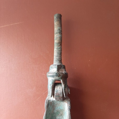 Antique bronze door knocker in hand shape