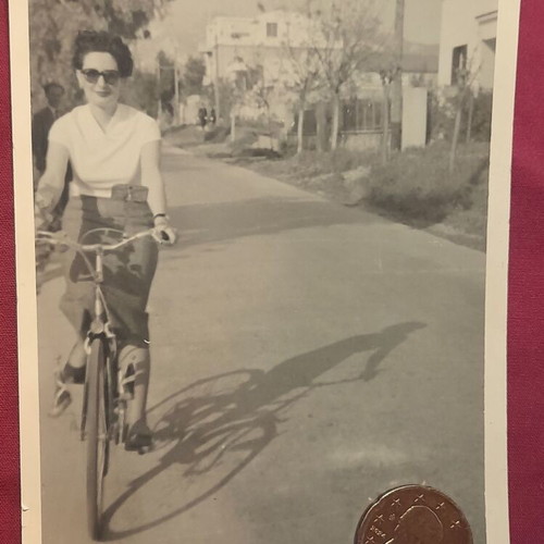 Vintage black and white photo woman with sunglasses on bicycle, like new
