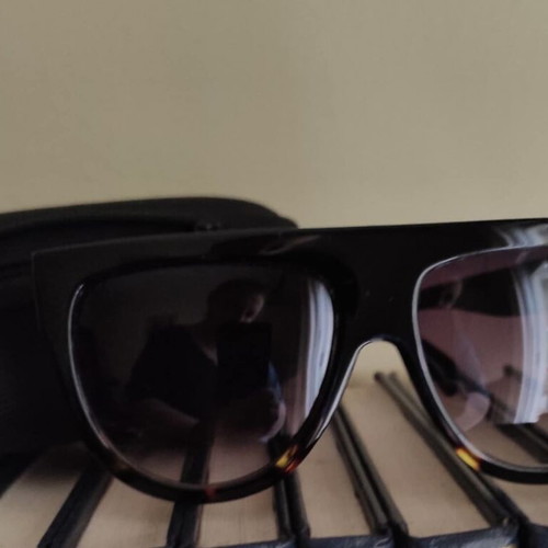 Women’s sunglasses new with case, black frame and brown lenses