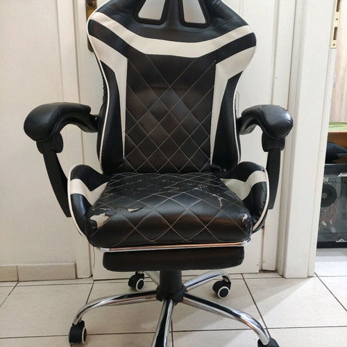 Gaming chair used with footrest made of leatherette