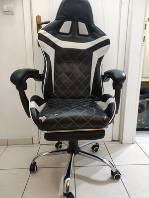 Gaming chair used with footrest made of leatherette