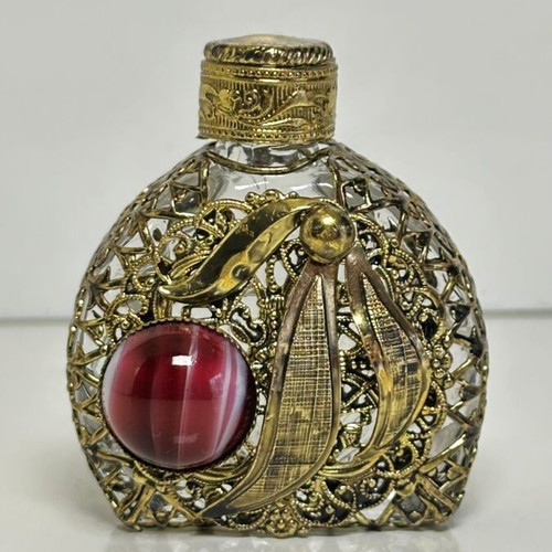 Vintage perfume flacon with filigree metalwork and red cabochon
