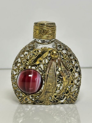 Vintage perfume flacon with filigree metalwork and red cabochon