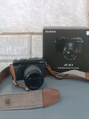 Fujifilm X-E1 mirrorless camera used with lens and strap