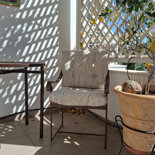Retro wrought iron garden armchair with cushions used