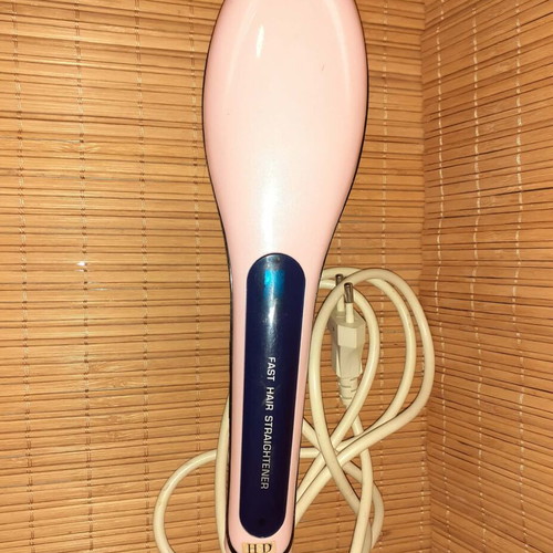 Electric hair straightening brush used